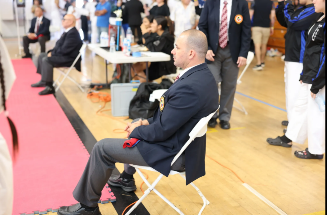 A man in a suit is sitting in a chair
