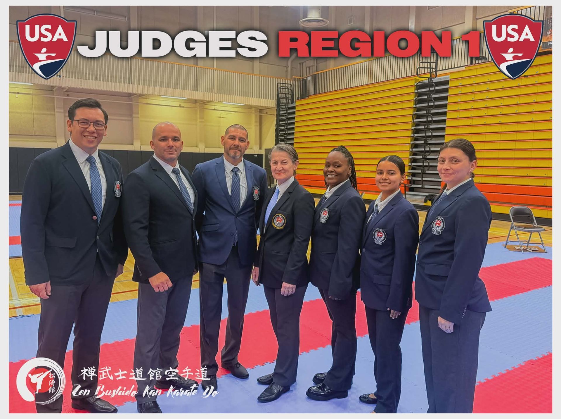 Judges from USA Region 1 at a martial arts event. People in suits and uniforms stand in a sports hall.