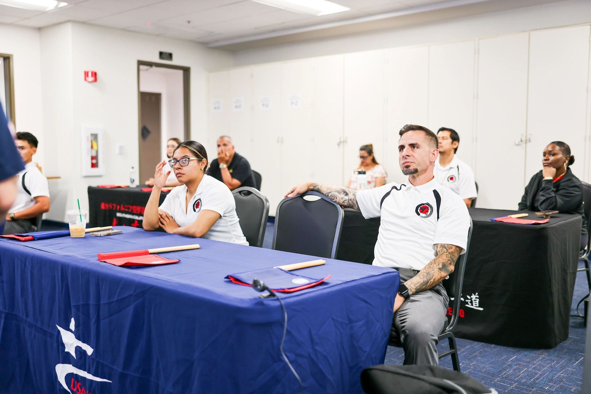 A group of people are sitting at tables in a room.