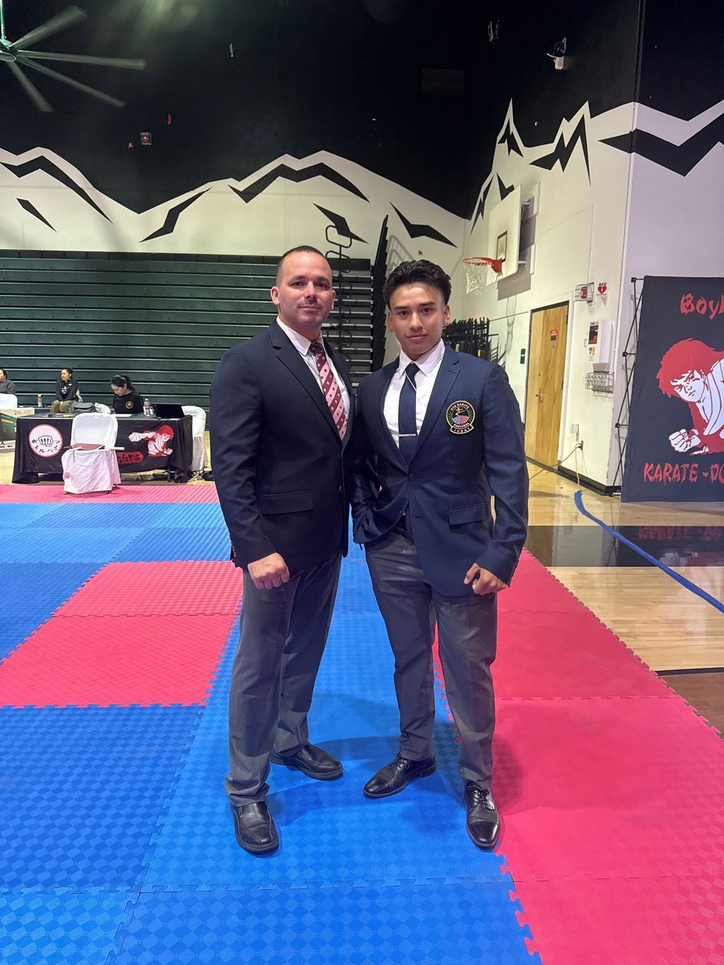 Two men standing together in the official uniforms