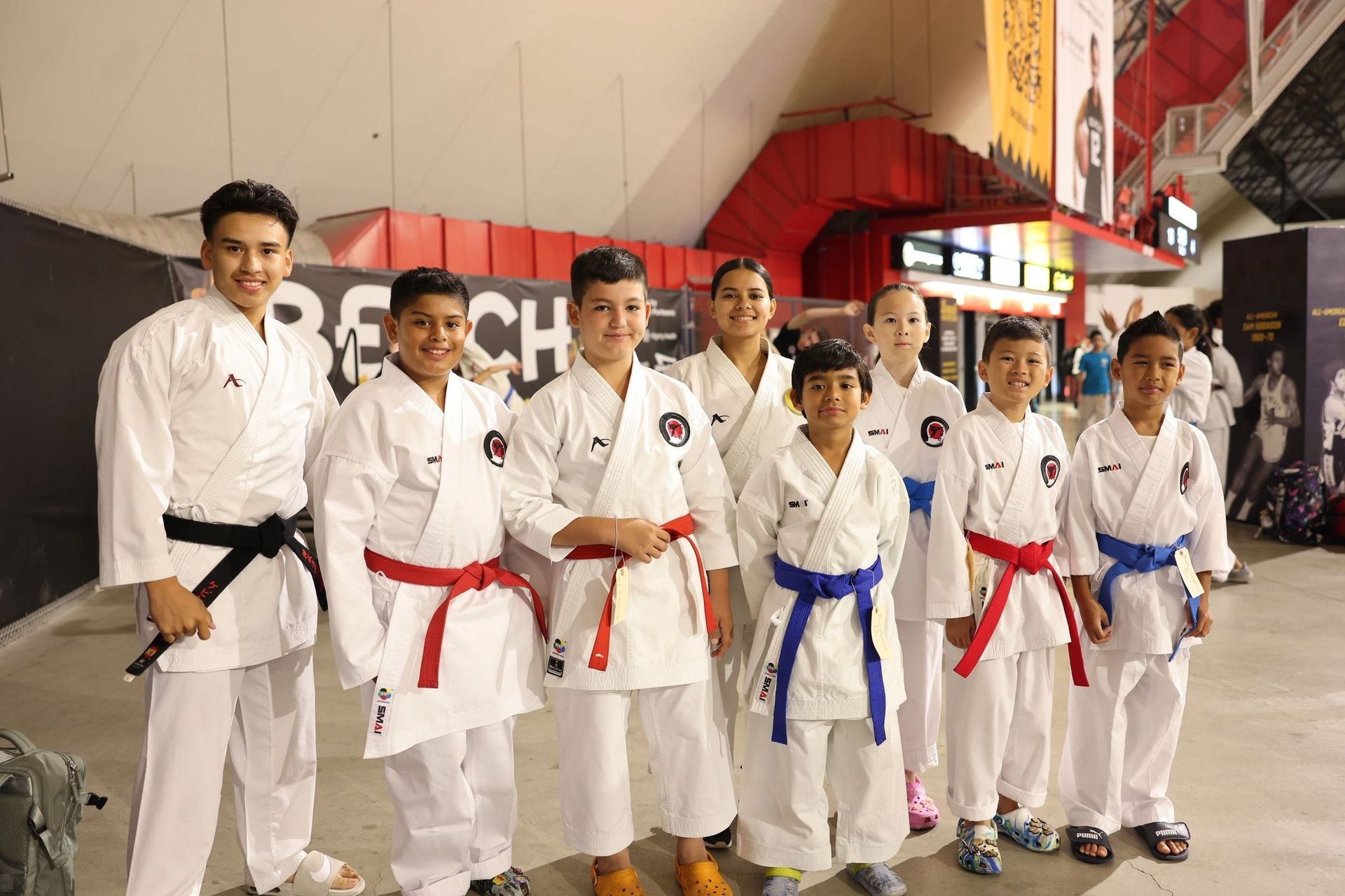 A group of young boys in karate uniforms are posing for a picture.