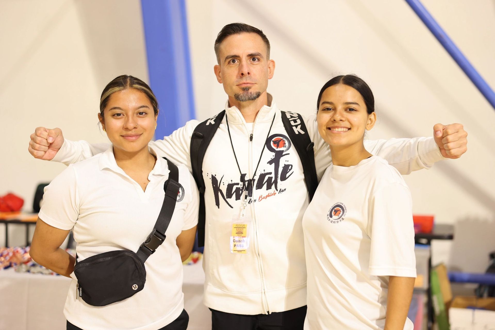 A man and two women are posing for a picture together.
