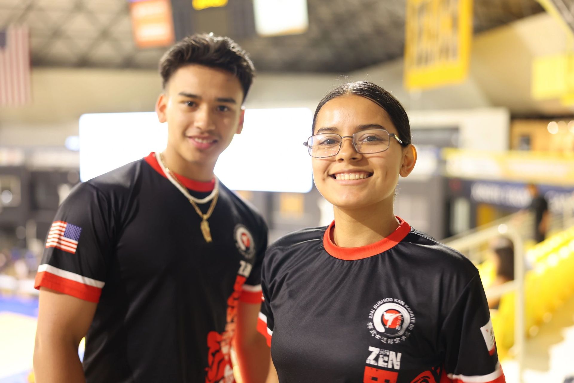 A man and a woman are posing for a picture in a gym.