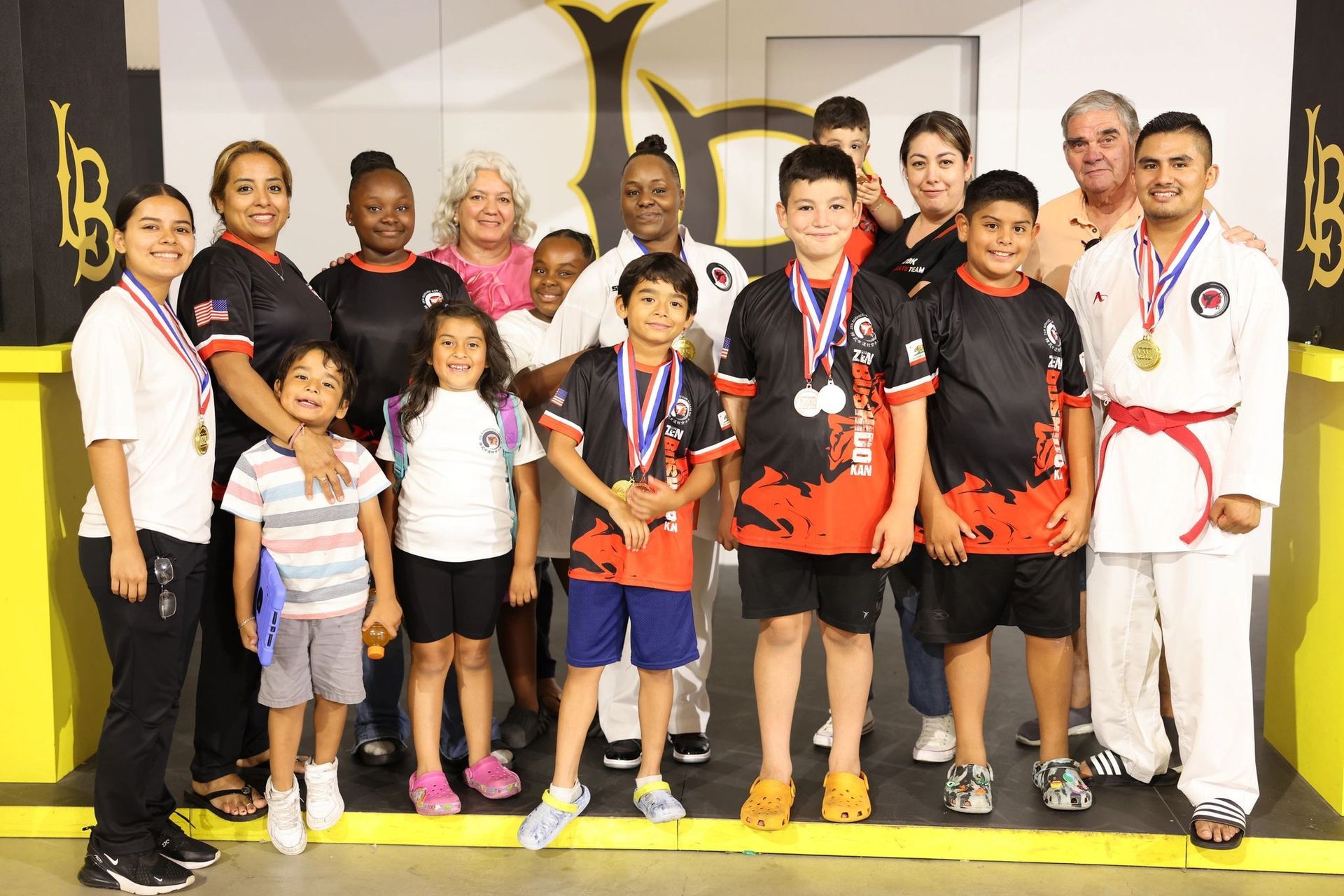 A group of people posing for a picture with medals around their necks.