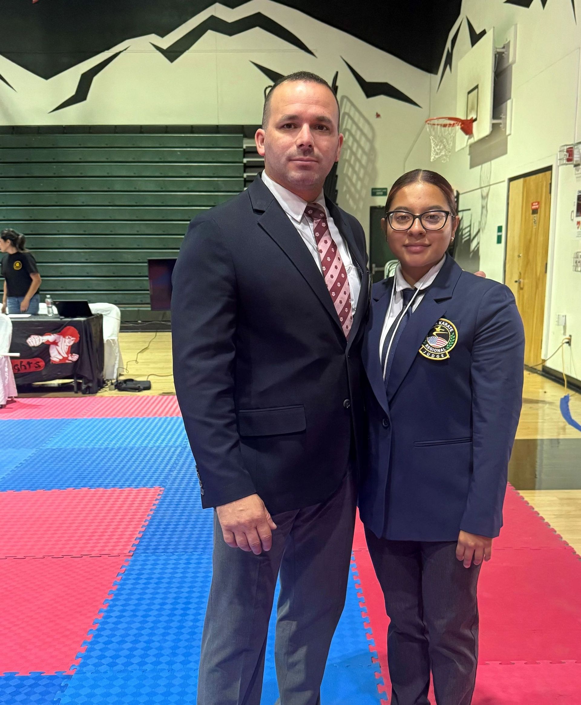 Two senseis standing together in the official uniforms