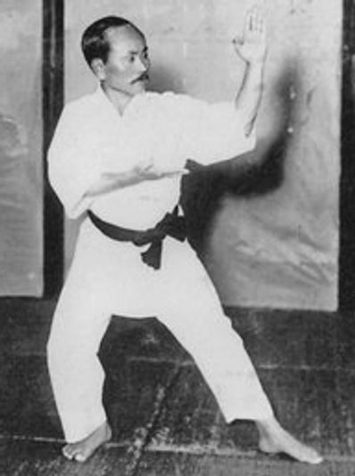 A black and white photo of a man practicing karate