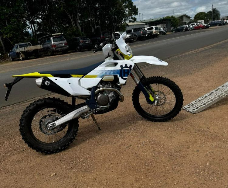 A Husqvarna Dirt Bike Is Parked On The Side Of The Road — Extreme Motorcycles In Atherton, QLD