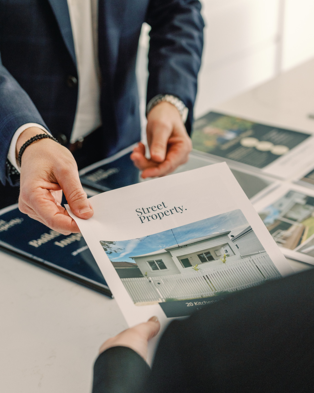 Professional Photoshoot for Street Property - Agent holding a brochure