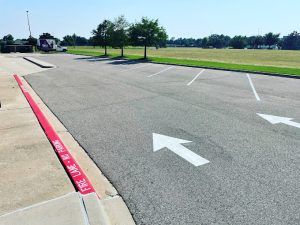 A parking lot with arrows painted on the side of the road