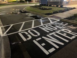 A do not enter sign is painted on the side of a road.