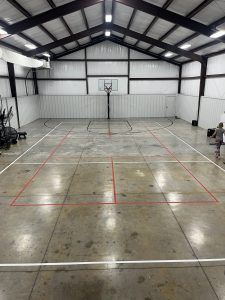 There is a basketball court in the middle of a building.