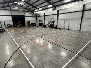 There is a basketball court in the middle of a building.