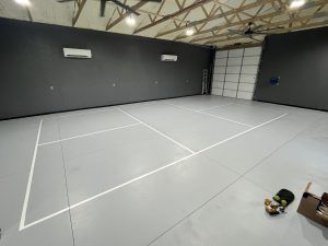 There is a tennis court in the middle of the room.