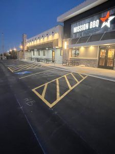 A large building with a handicapped parking spot in front of it.