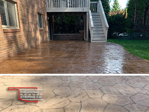 A patio with a deck and stairs in the backyard of a house.