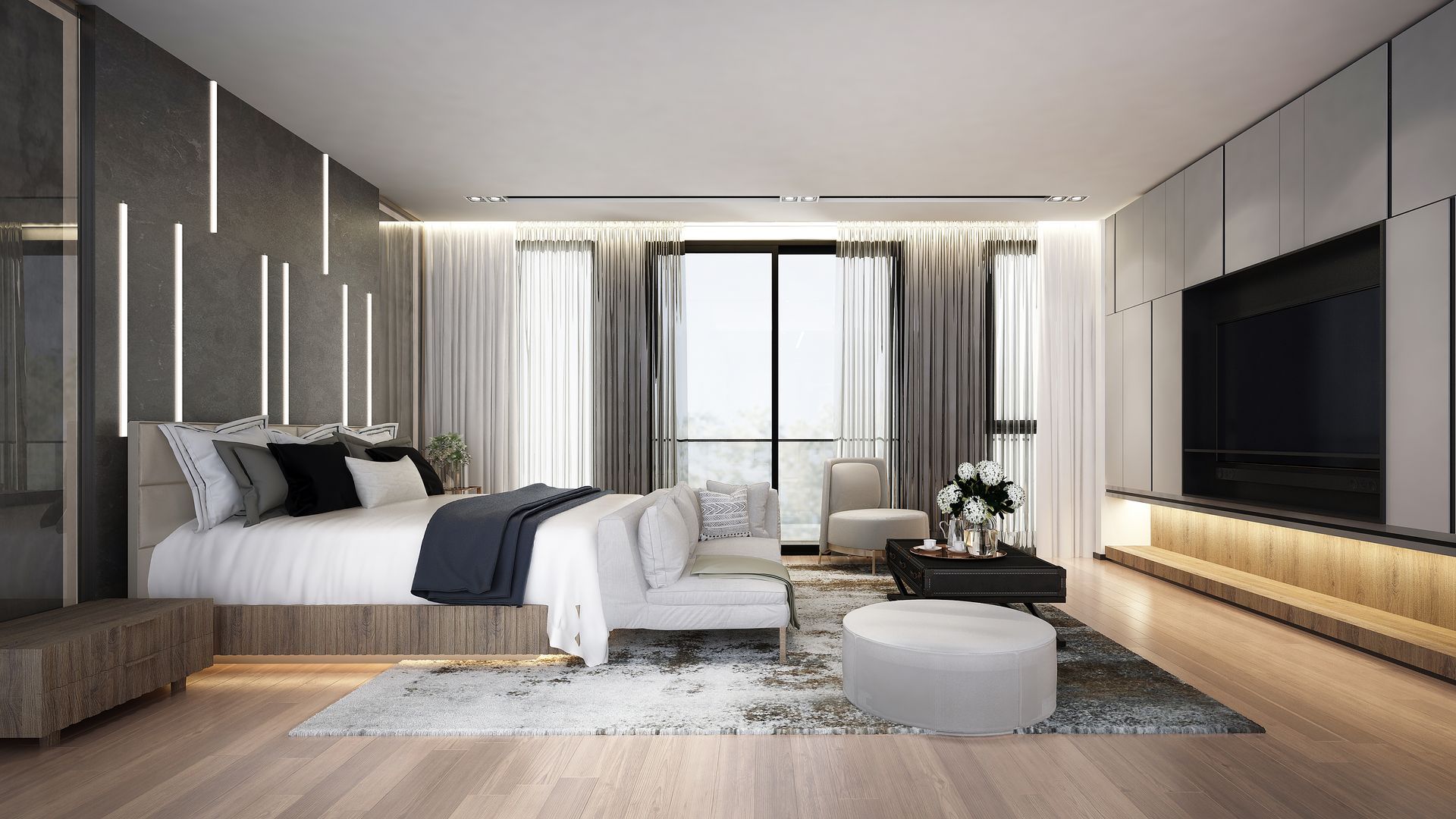 Modern bedroom with bed, sofa, and a large TV. Gray and neutral color scheme, with a balcony.