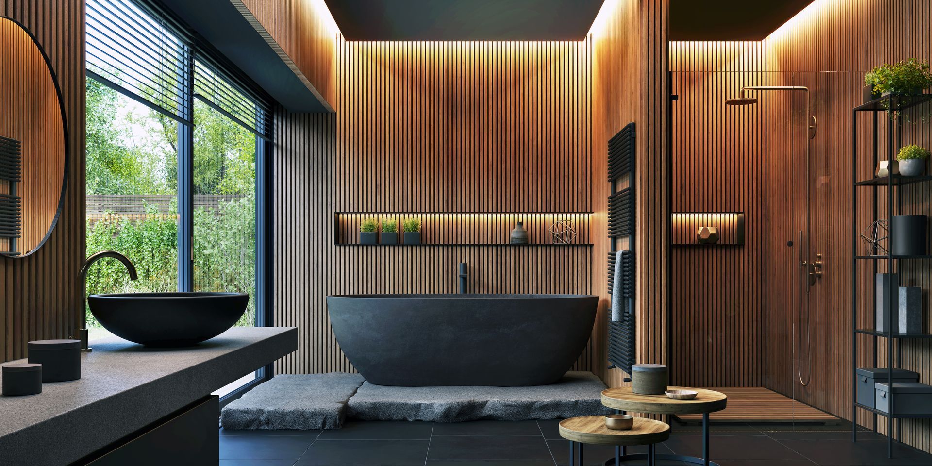 A modern bathroom with wood paneling, a black tub, and sink, and a view of greenery.