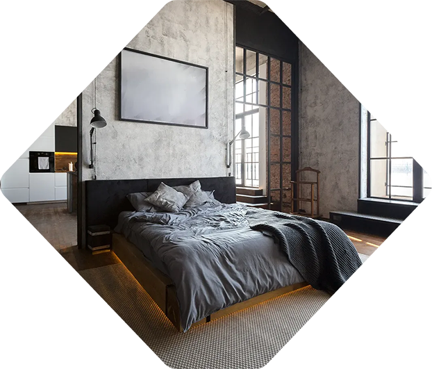 Chambre de style industriel avec literie grise, une grande œuvre d'art encadrée et une fenêtre à cadre métallique.