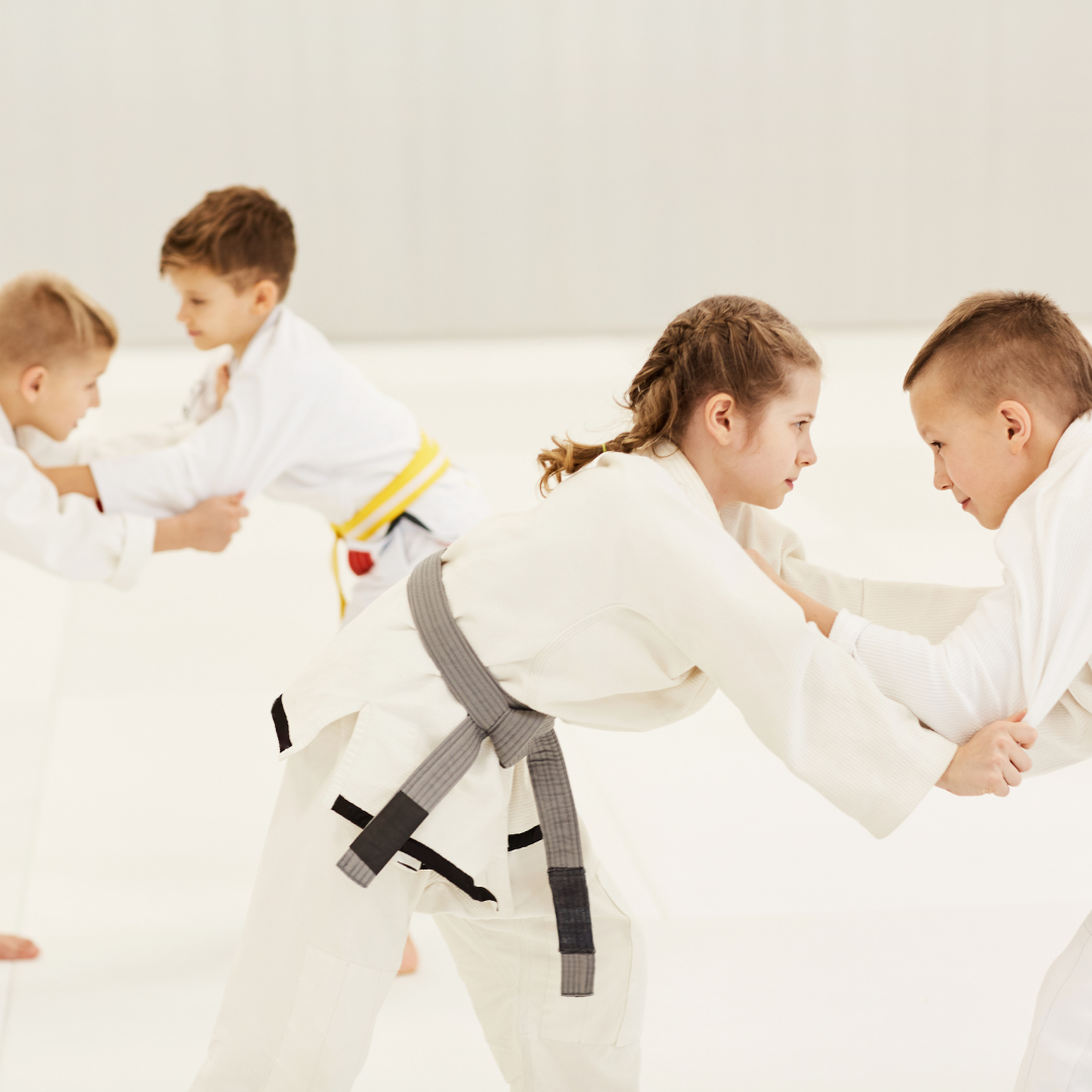 A boy and a girl are practicing taekwondo together.