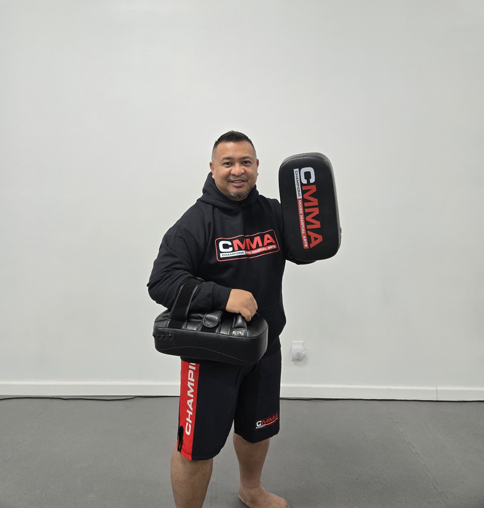 Carlos Machado wearing a white brazilian jiu jitsu uniform with the word machado on it