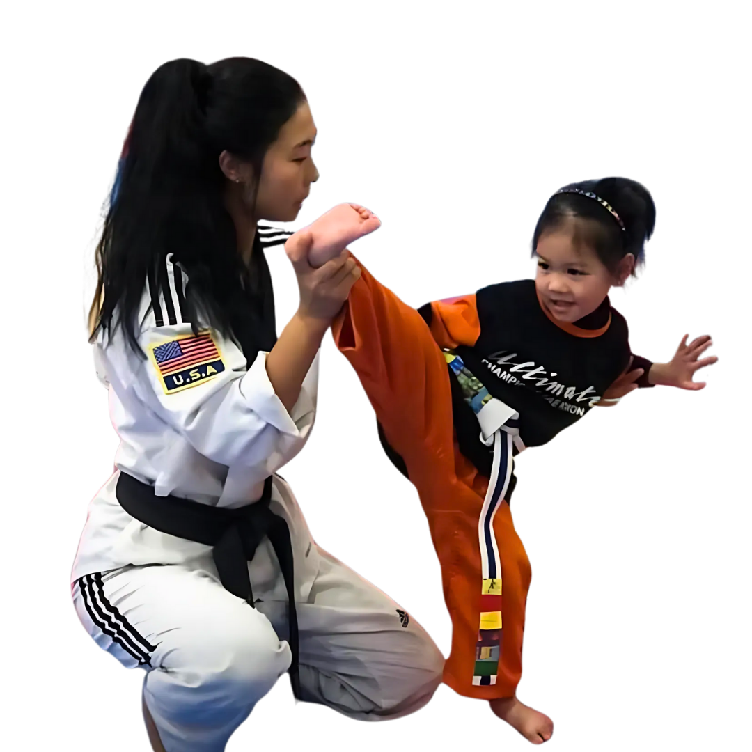 A boy and a girl are practicing karate together.