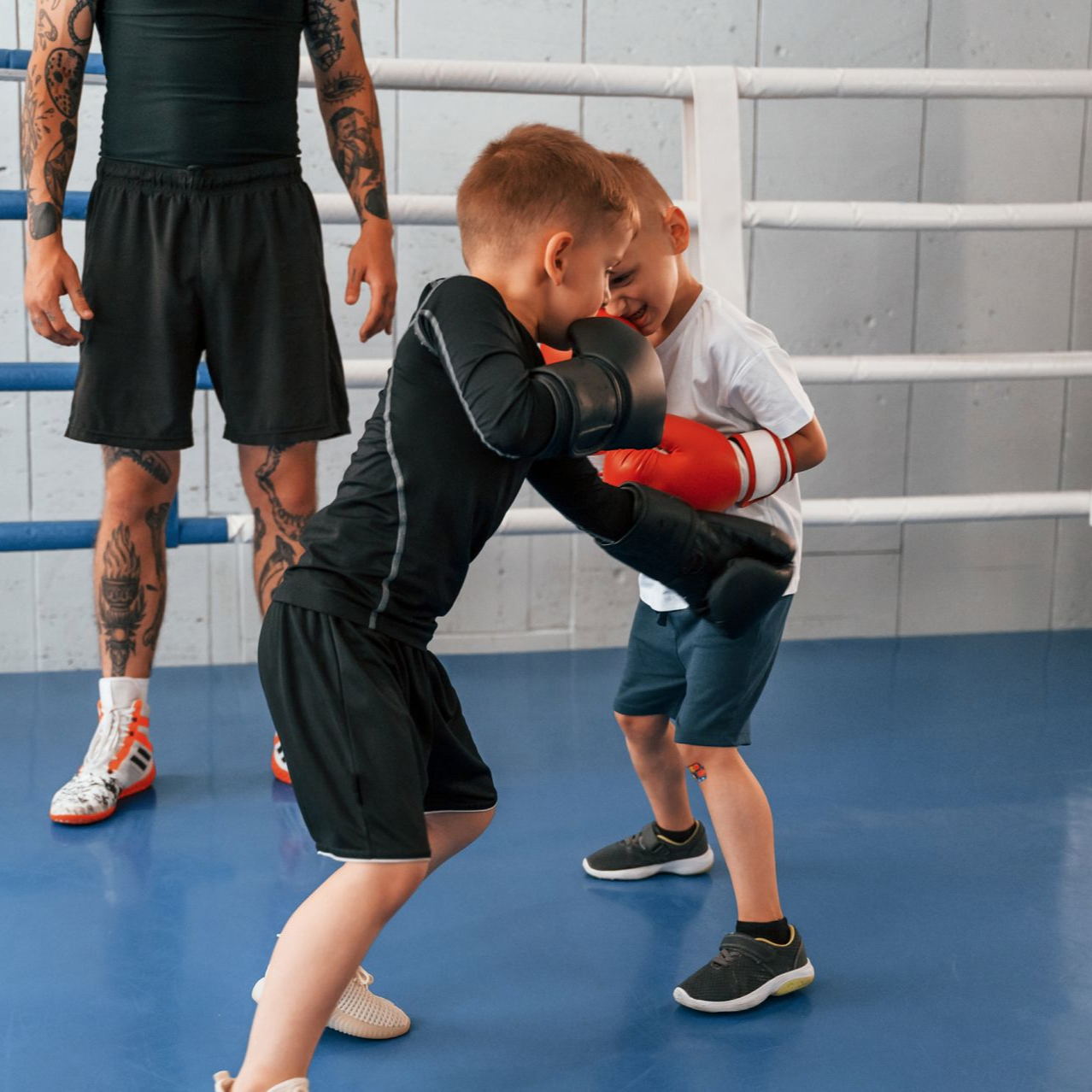 A boy and a girl are practicing taekwondo together.
