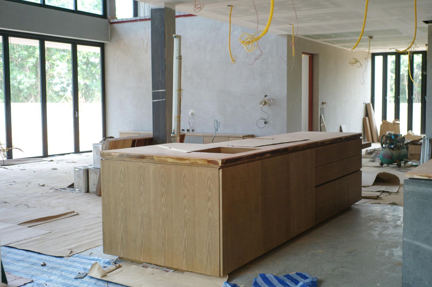 A kitchen with wooden cabinets , granite counter tops , stainless steel appliances and a large island.