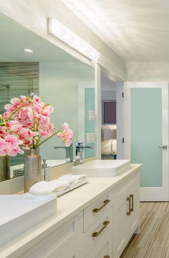 A bathroom with two sinks and a large mirror.