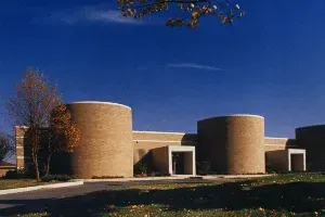 A large brick building with a blue sky in the background.