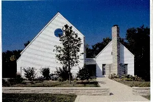 A white house with a blue sky in the background