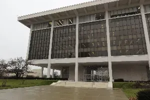 A large building with a lot of windows on a rainy day.