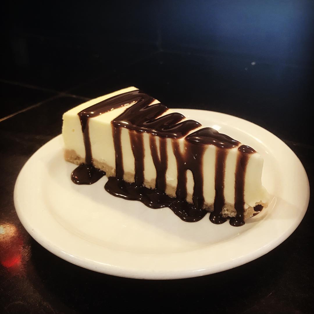 slice of cheesecake with hot fudge