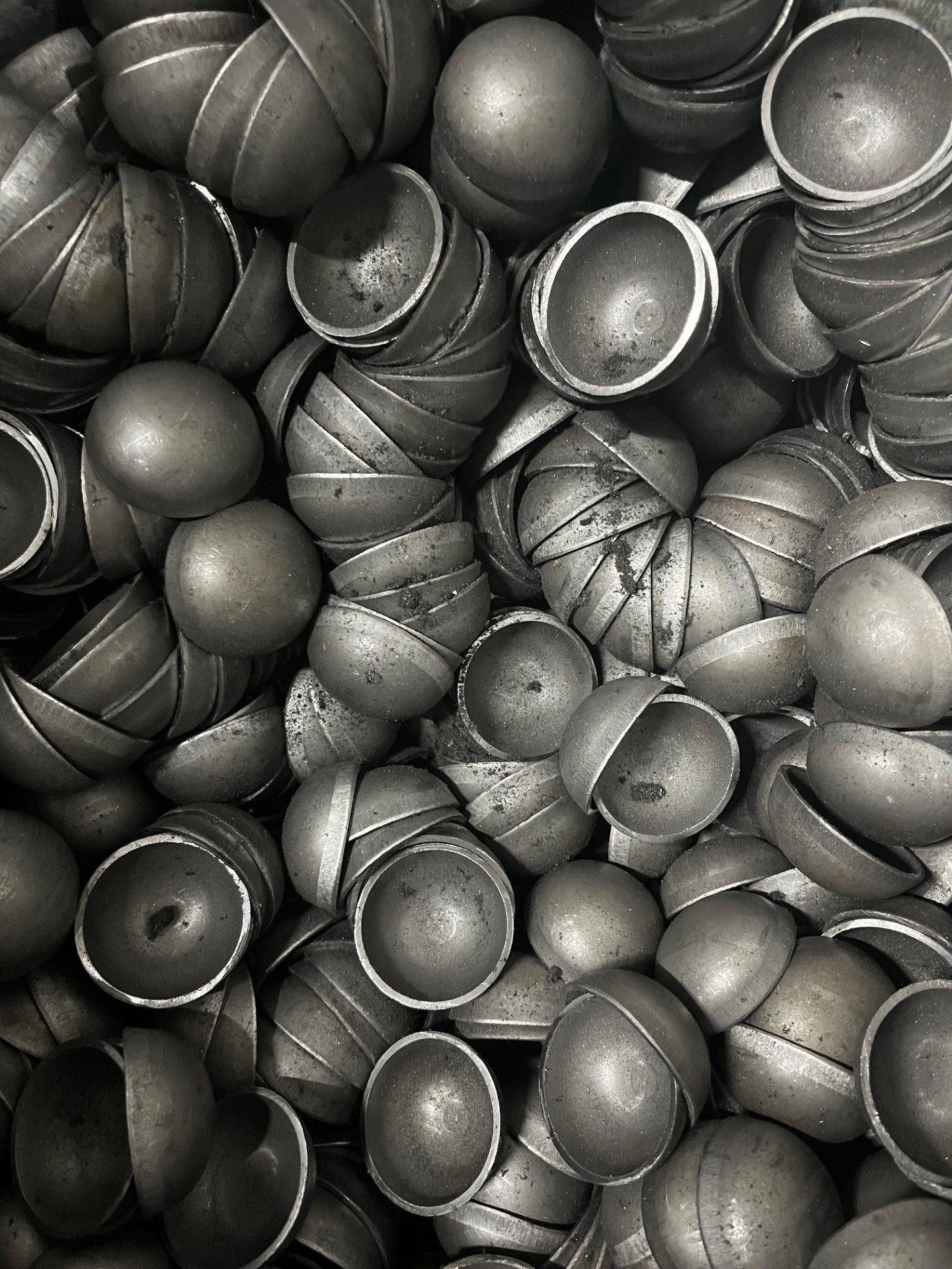 A bunch of metal pieces are stacked on top of each other on a table.