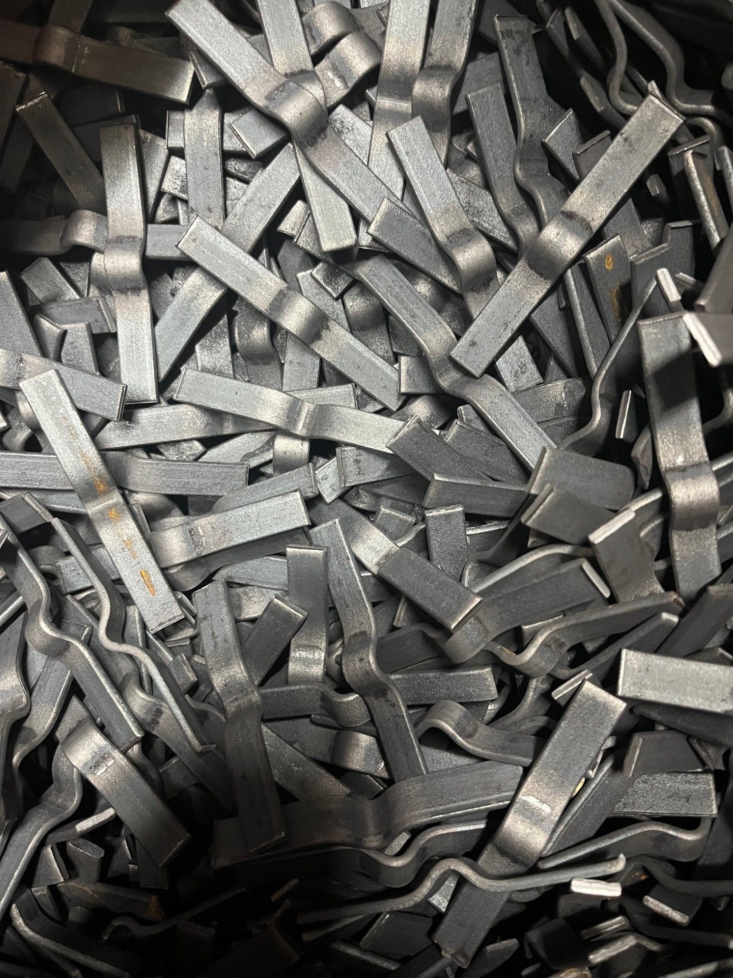 A bunch of metal pieces are stacked on top of each other on a table.