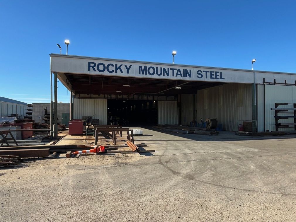 A large white building with a sign that says rocky mountain steel