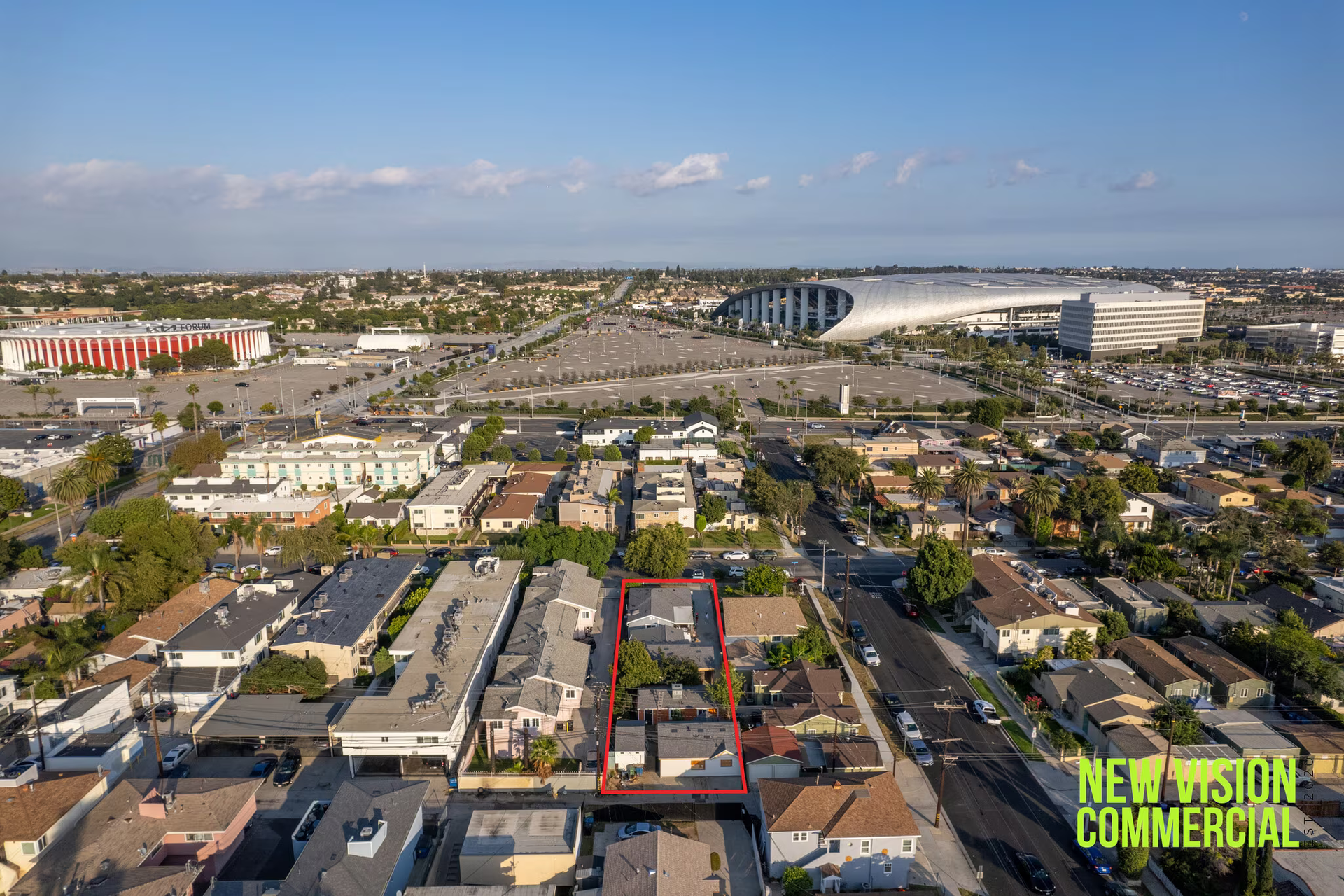 An aerial view of a city with a large building in the background.