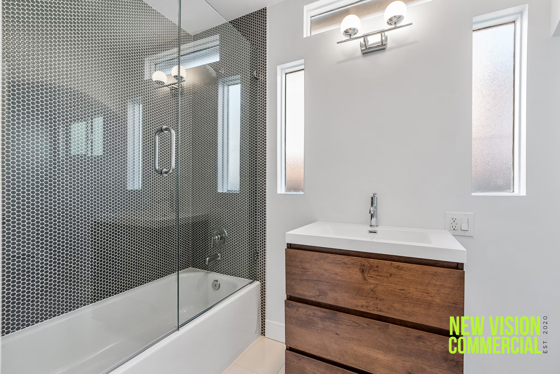 A bathroom with a sink , bathtub and shower.