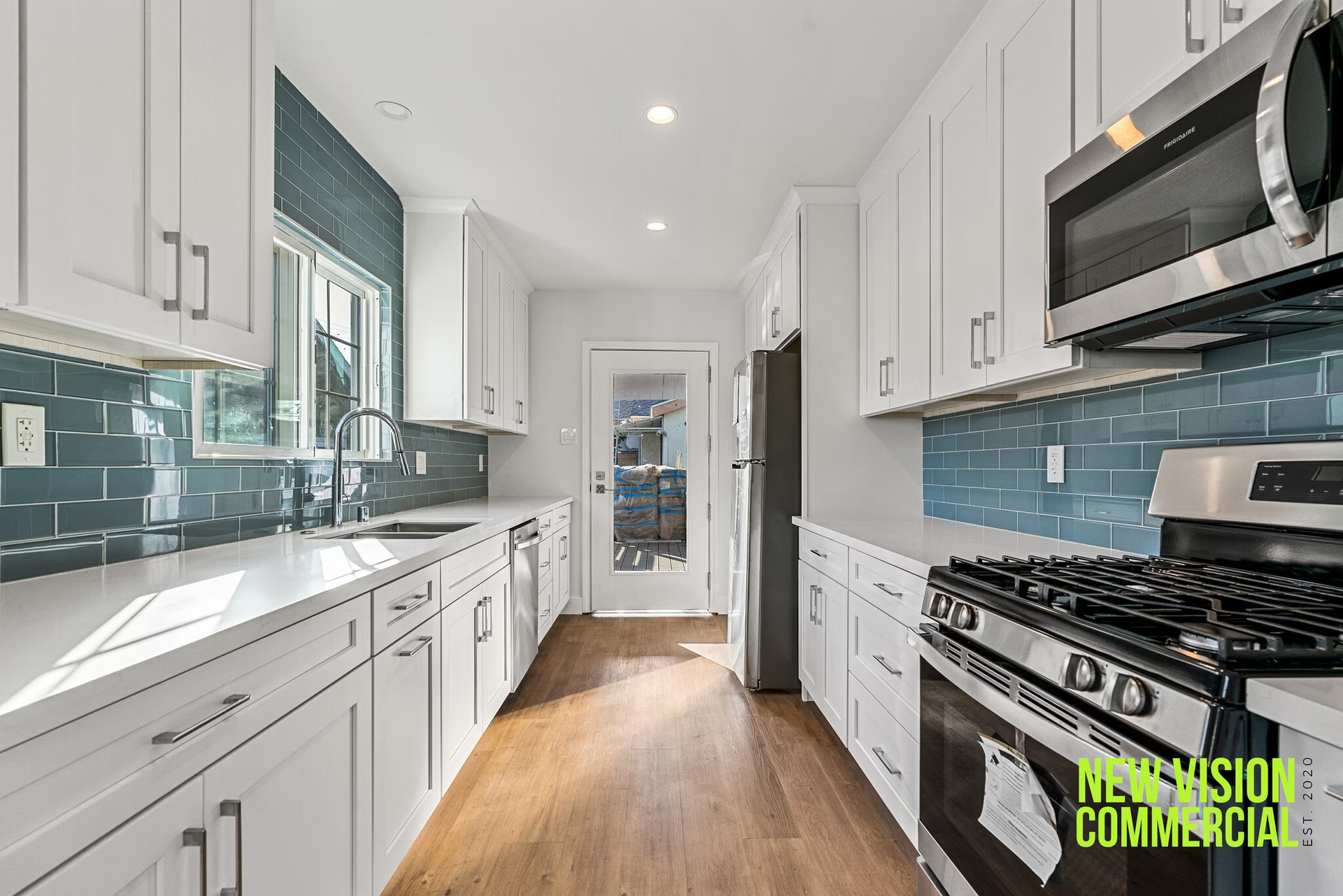 A kitchen with white cabinets and stainless steel appliances.