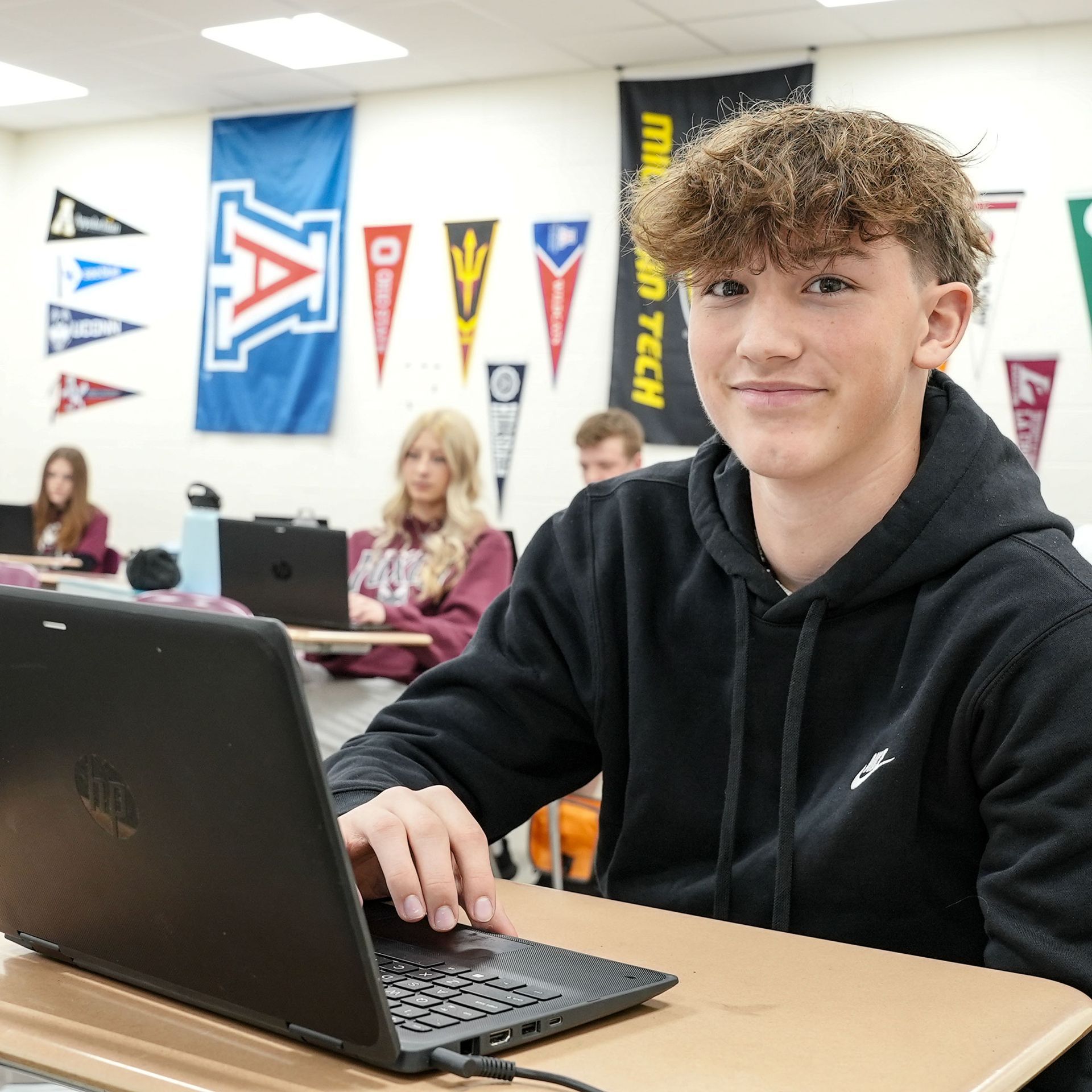 Smiling boy working at a desk 