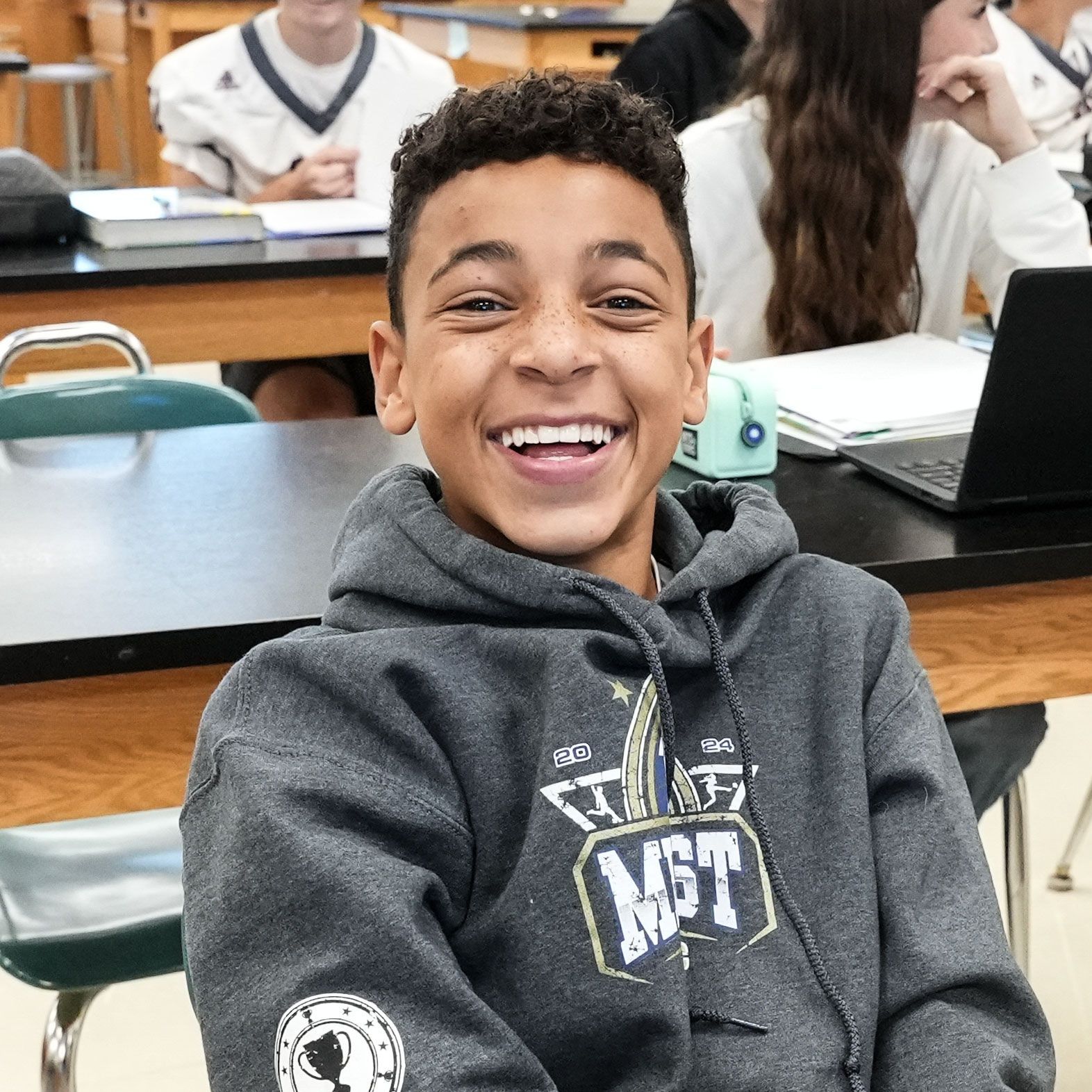 Smiling boy at a science table