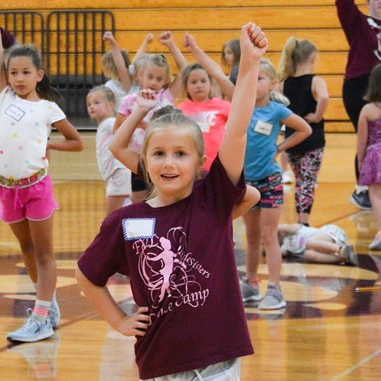 Happy girl participating in a previous dance camp