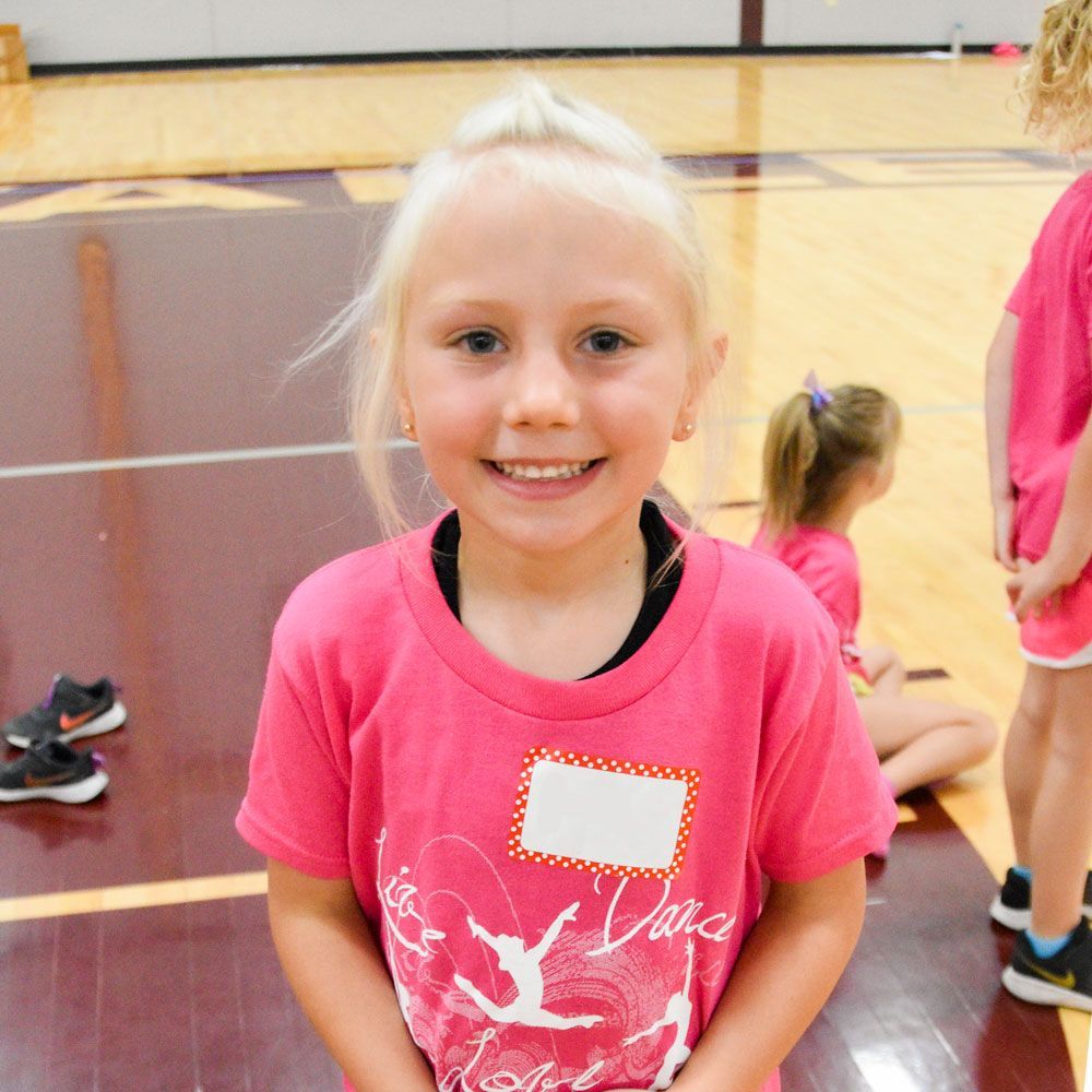 Smiling, young dance camp participant