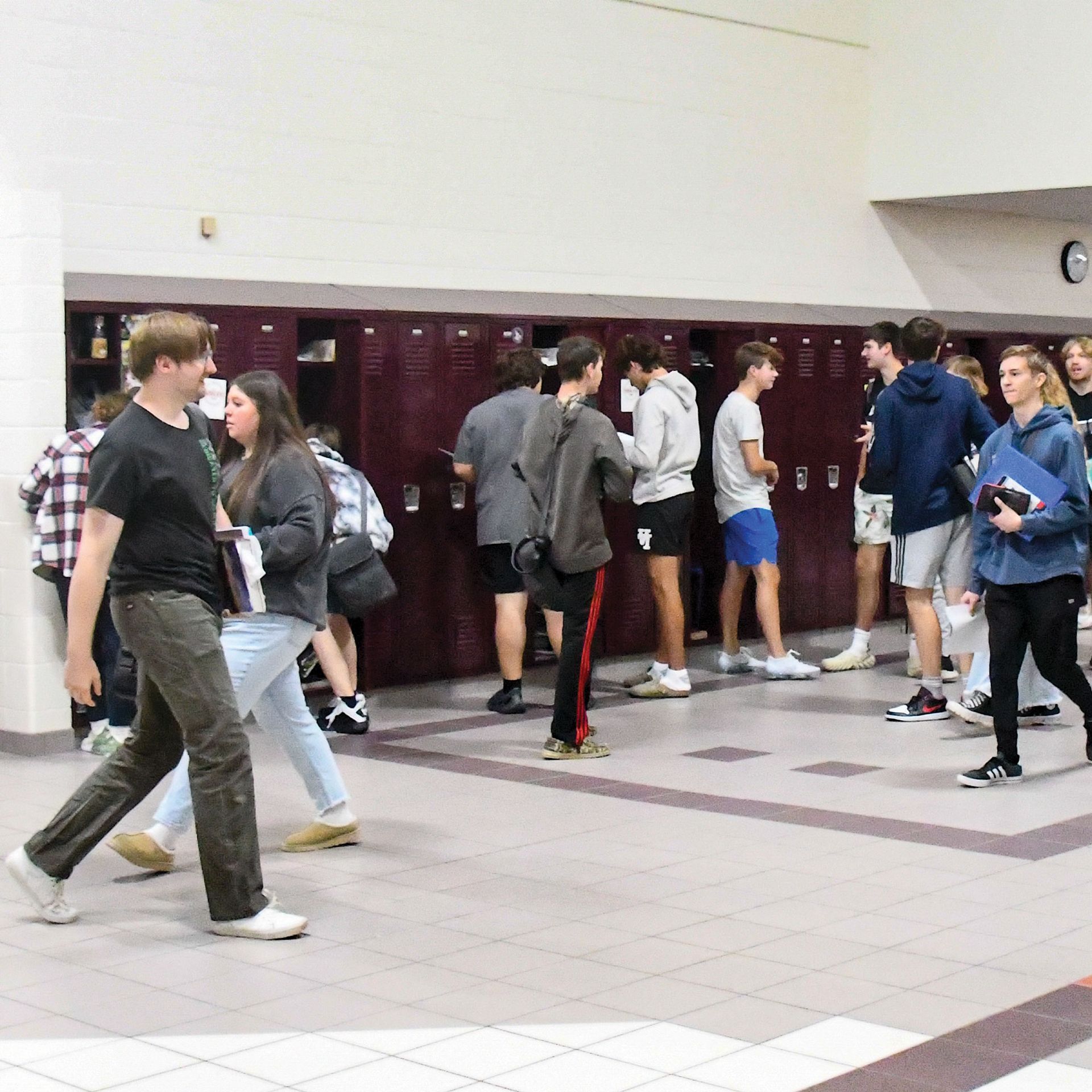Students walking by new lockers in what used to be the pits area