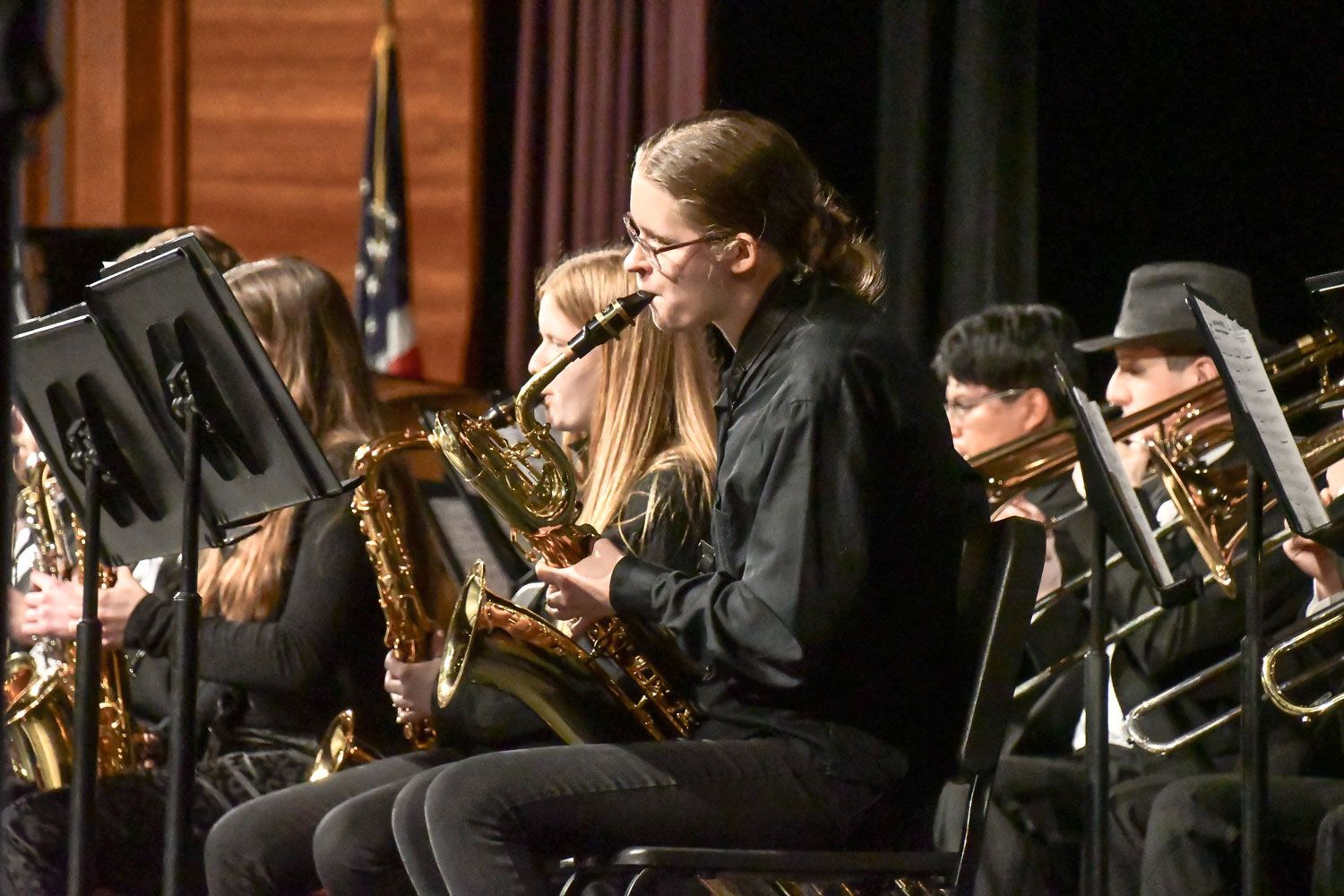 Band students playing instruments - saxophones are featured
