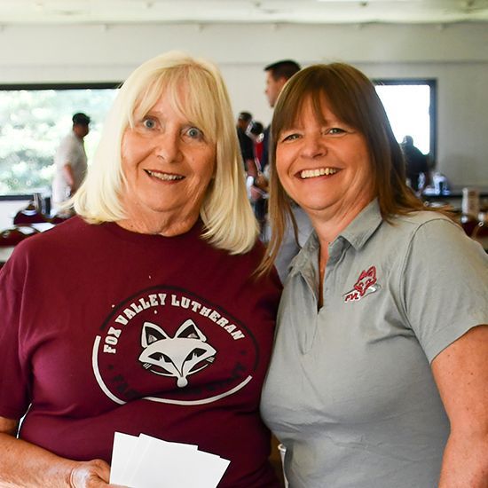 Two happy women in FVL clothing, inside the clubhouse
