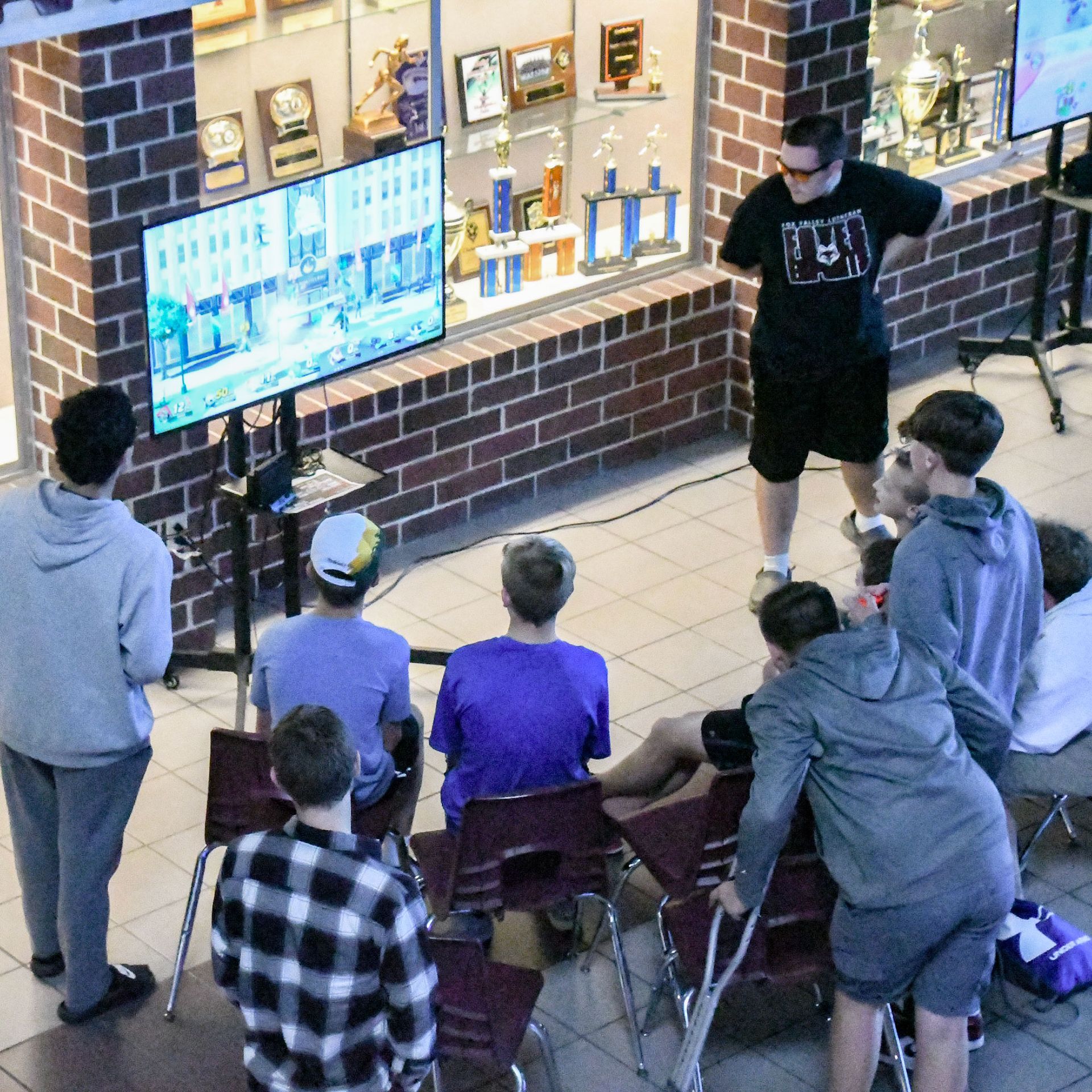 Group of students playing video game in Commons