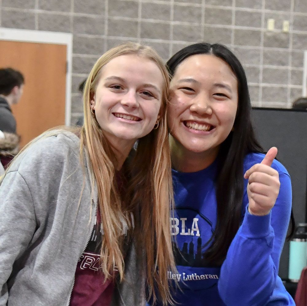 Two happy and smiling female FVL students in Commons