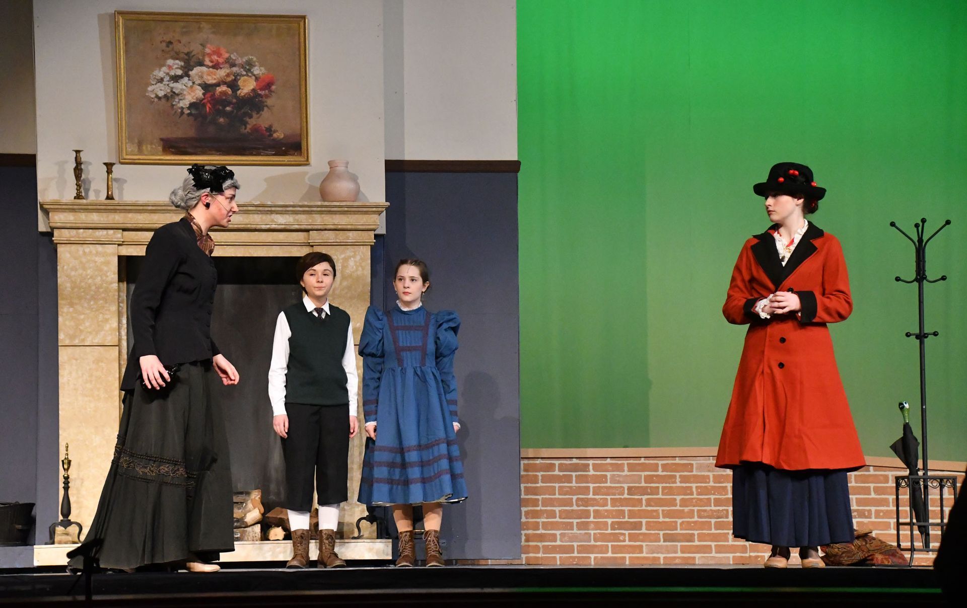 Jane, Michael, Mary Poppins, and Miss Andrew inside, by the fireplace.