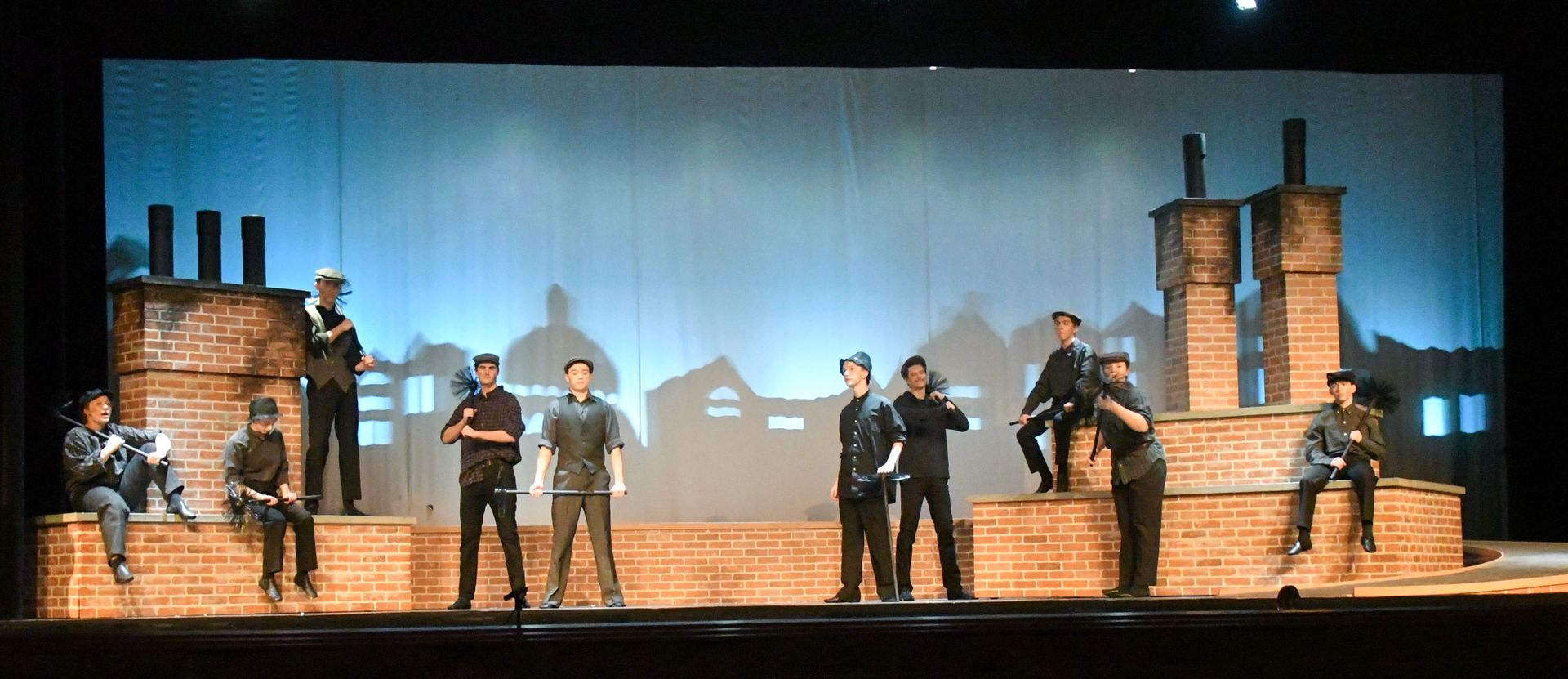 Many chimney sweeps on the roof.