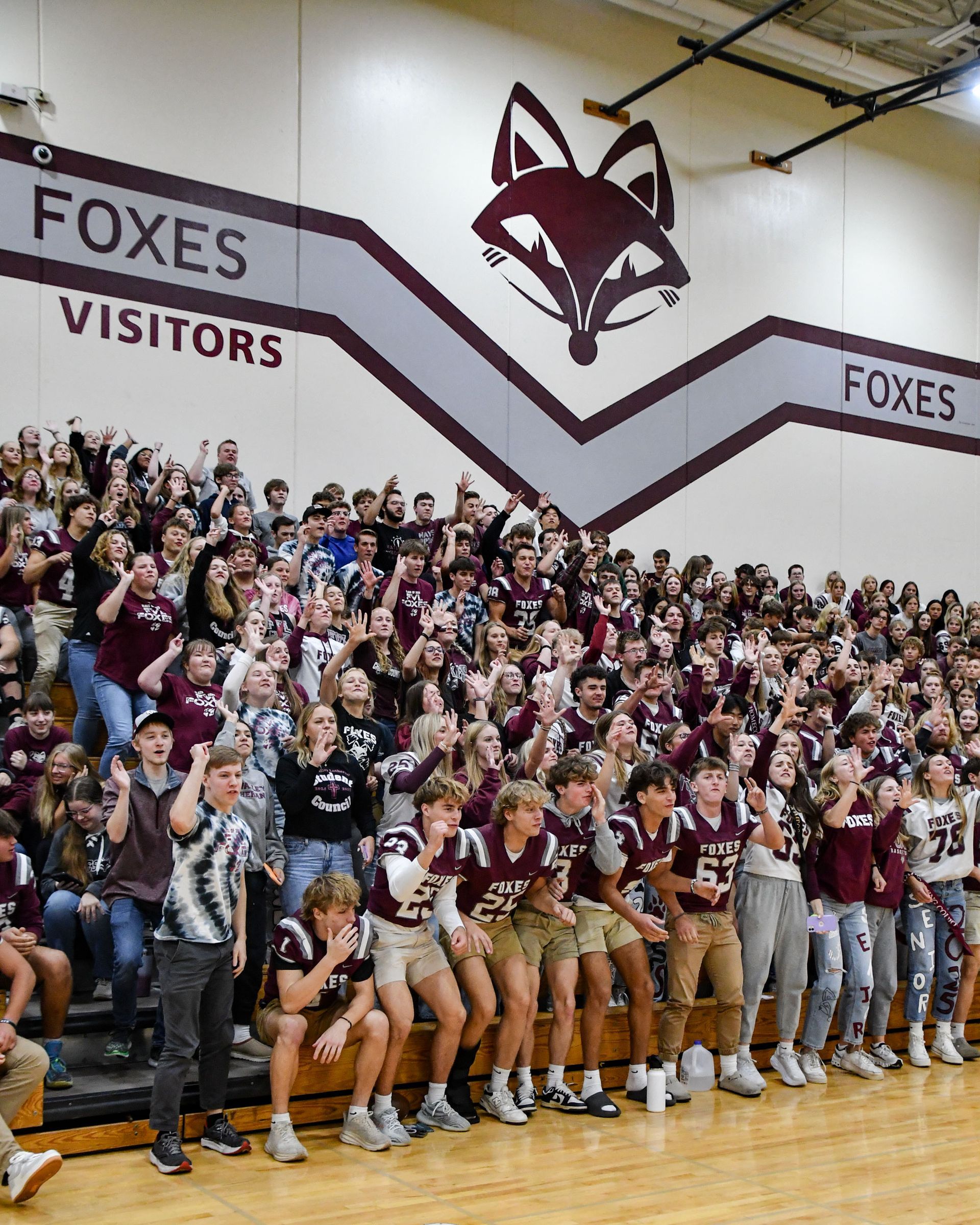 Cheering students in the gym bleachers